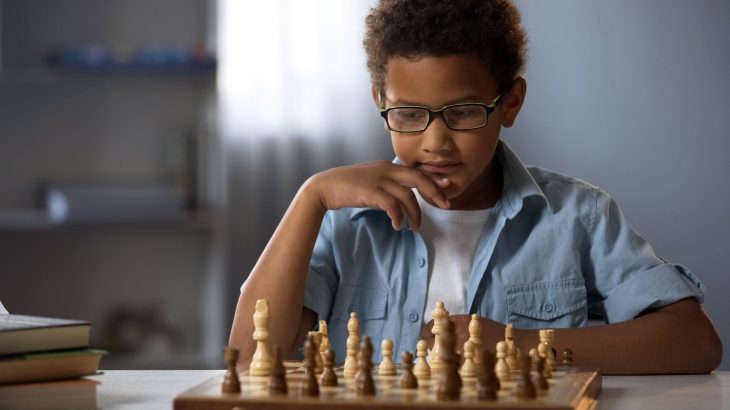 Boy at Chess Board which builds cognitive skills