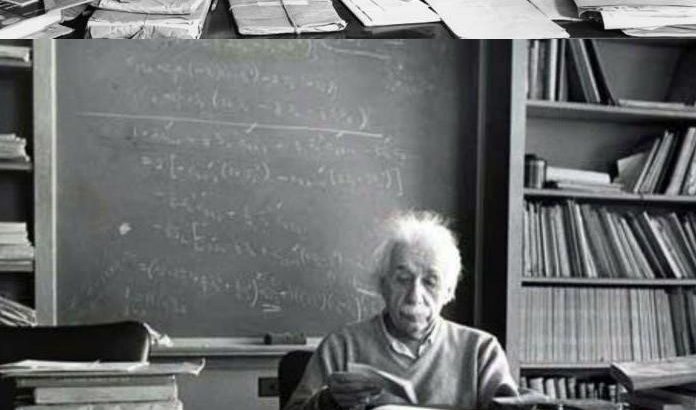 Organization: Einstein at his desk, covered with books and papers.