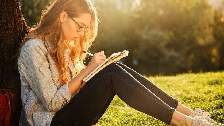 Teen writer working outside