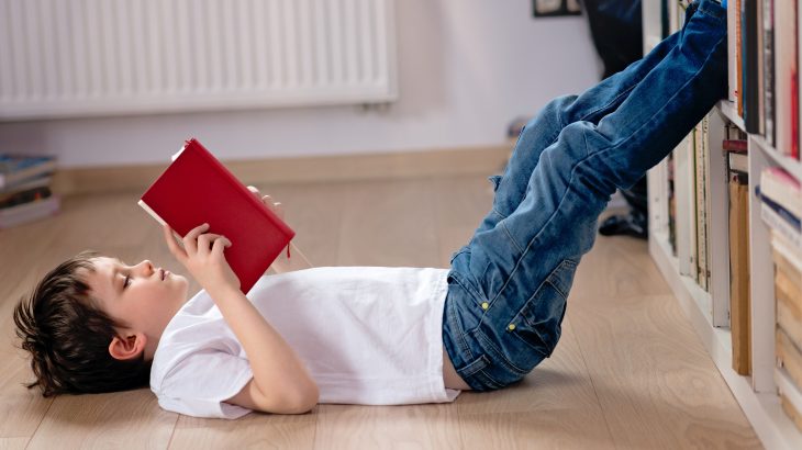 Kid on library floor reading