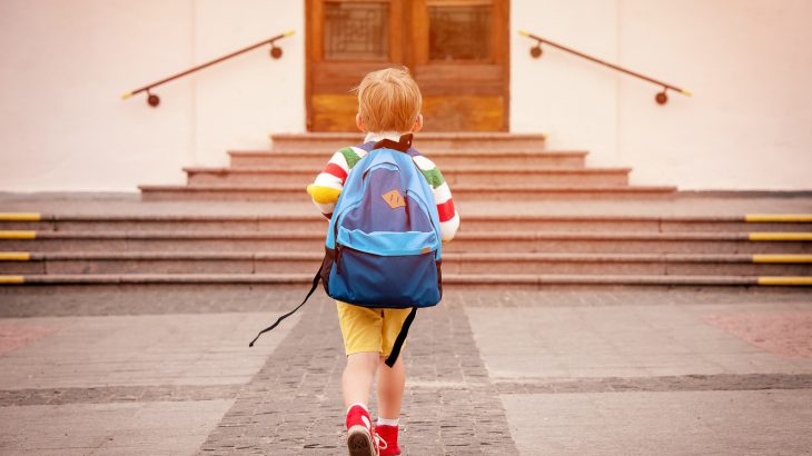 Child walking up to a school